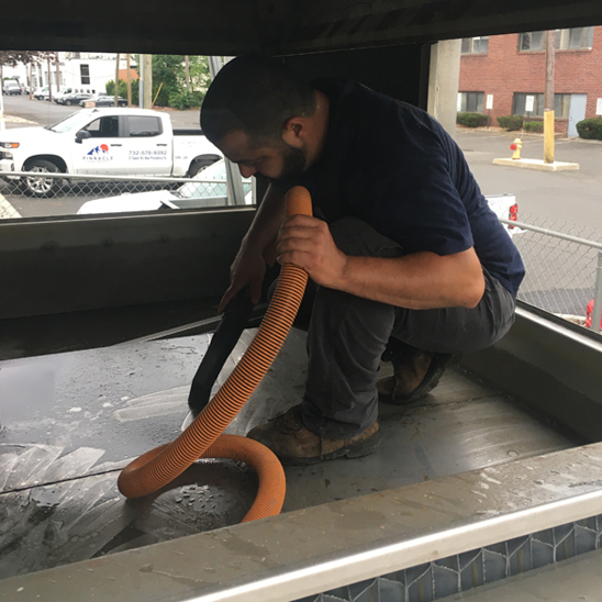 Vacuuming Debris from lower sump of an Evapco LSTE Cooling Tower